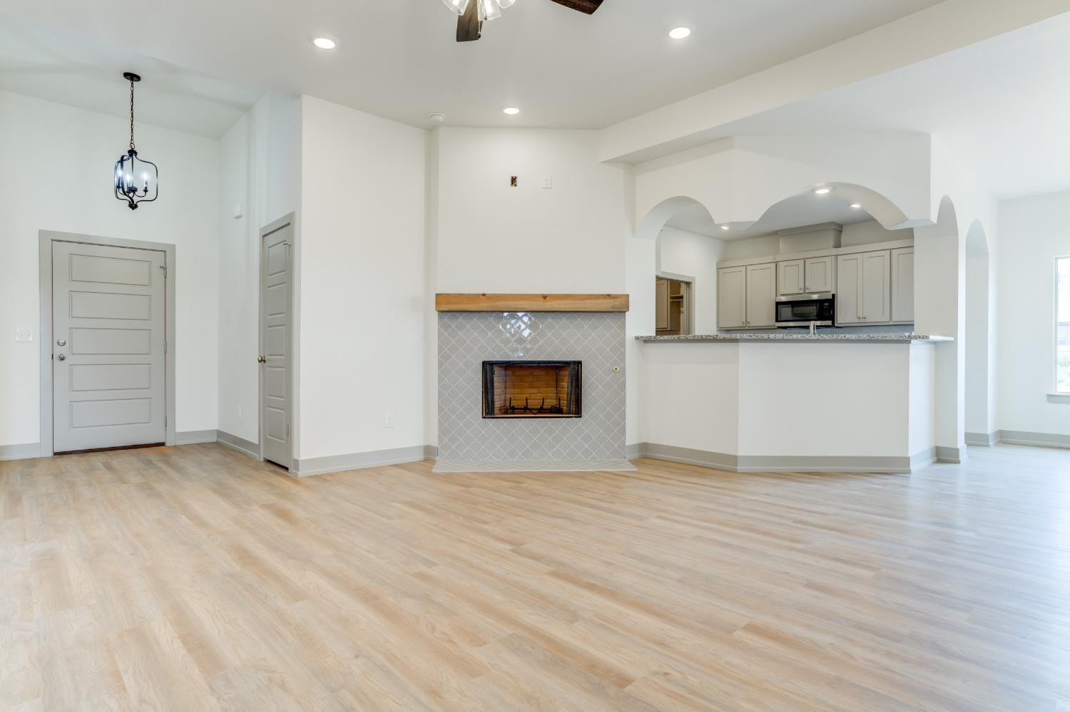 7007 18th Street Lubbock, TX 79416 - Photo 7 of 34 a view of kitchen with granite countertop cabinets and wooden floor