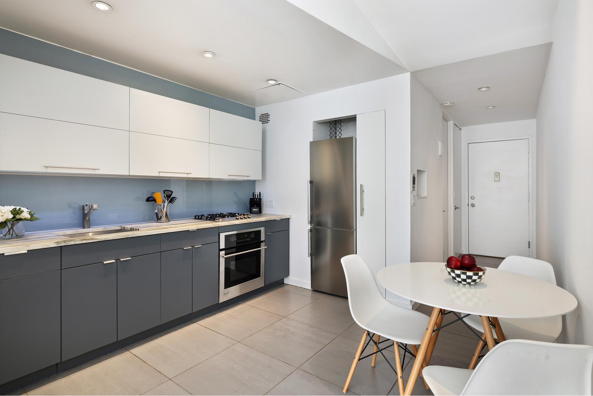 3 Hanover Square, Unit 9G Manhattan, NY 10004 - Photo 5 of 10 a kitchen with stainless steel appliances granite countertop a sink dishwasher and cabinets