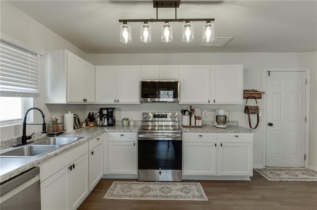 565 Bryson Trail Monroe, GA 30655 - Photo 12 of 43 a kitchen with stainless steel appliances a sink stove and cabinets