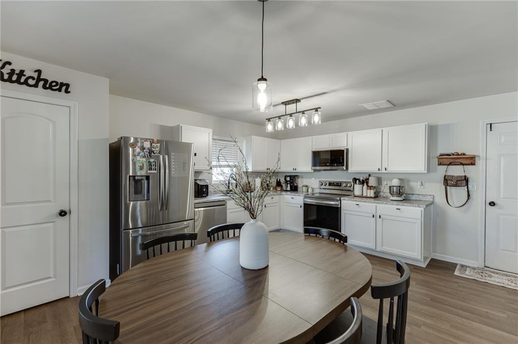 565 Bryson Trail Monroe, GA 30655 - Photo 15 of 43 a kitchen with sink refrigerator and microwave