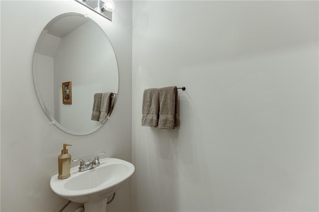 565 Bryson Trail Monroe, GA 30655 - Photo 16 of 43 a bathroom with a sink and mirror