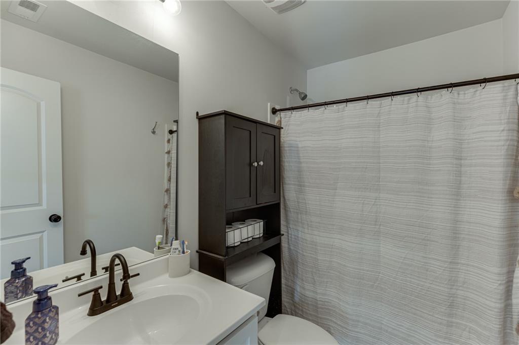 565 Bryson Trail Monroe, GA 30655 - Photo 23 of 43 a bathroom with a sink a toilet and a mirror