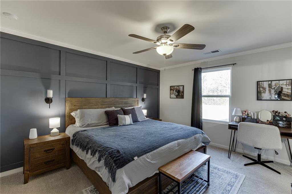 565 Bryson Trail Monroe, GA 30655 - Photo 26 of 43 a bedroom with a bed a couch and a window