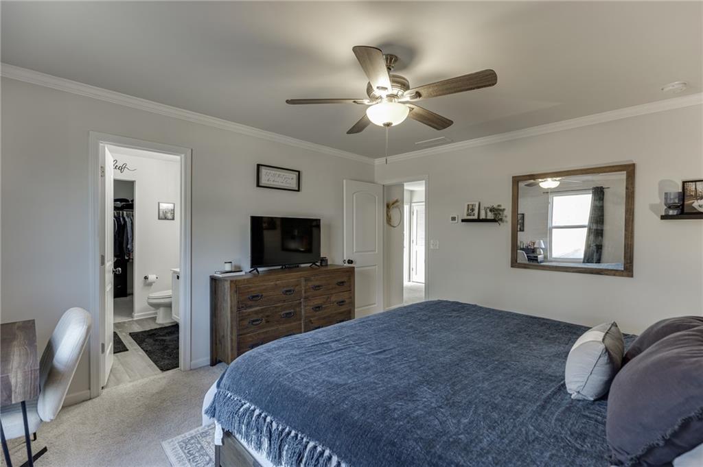 565 Bryson Trail Monroe, GA 30655 - Photo 28 of 43 a bedroom with a bed and a flat screen tv