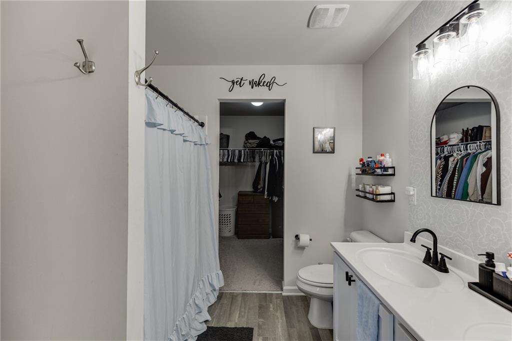 565 Bryson Trail Monroe, GA 30655 - Photo 29 of 43 a bathroom with a sink vanity mirror and toilet