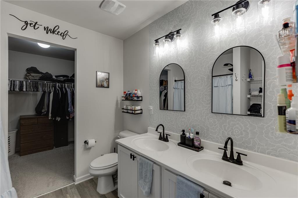 565 Bryson Trail Monroe, GA 30655 - Photo 30 of 43 a bathroom with double sink and a toilet