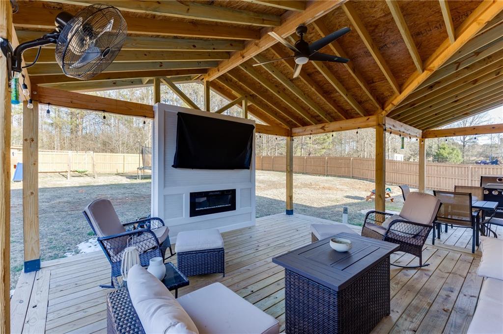 565 Bryson Trail Monroe, GA 30655 - Photo 34 of 43 a living room with furniture a fireplace with a flat screen tv