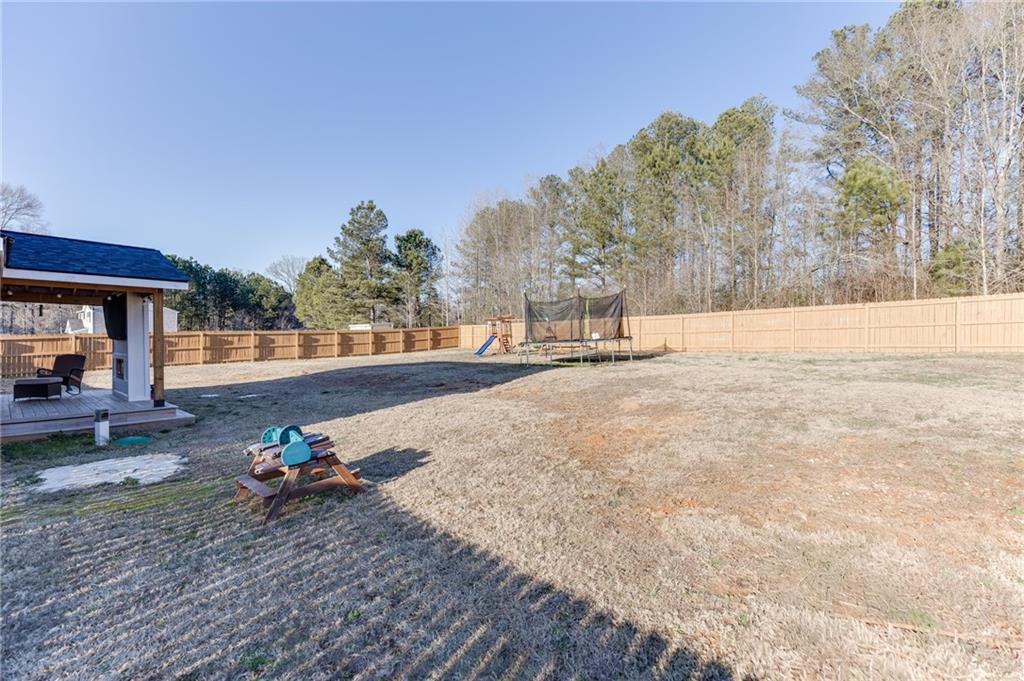 565 Bryson Trail Monroe, GA 30655 - Photo 38 of 43 a backyard of a house with table and chairs