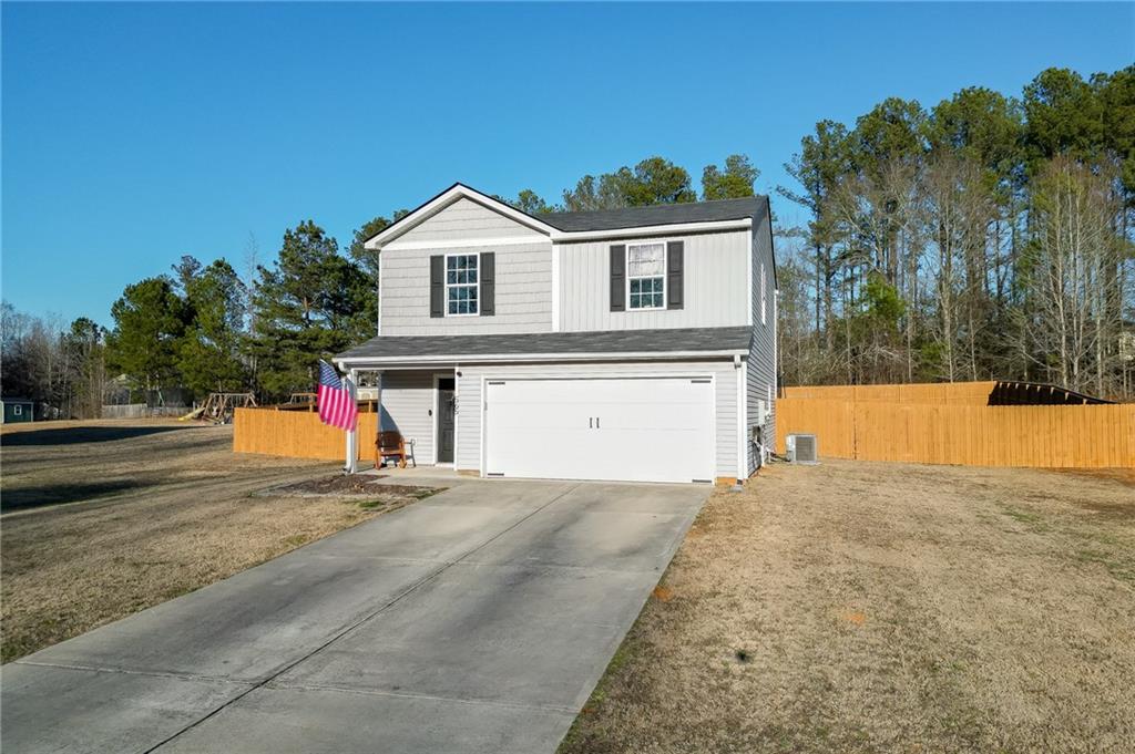 565 Bryson Trail Monroe, GA 30655 - Photo 39 of 43 a front view of a house with a yard and garage