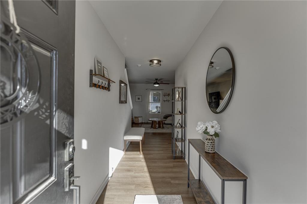 565 Bryson Trail Monroe, GA 30655 - Photo 4 of 43 a hallway with a large mirror and a wooden floor