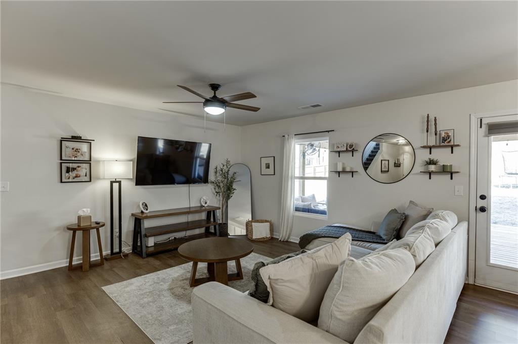 565 Bryson Trail Monroe, GA 30655 - Photo 5 of 43 a living room with furniture a flat screen tv and a window