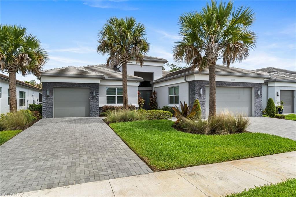 12033 Azalea Way Naples, FL 34120 - Photo 1 of 46 Curb appeal with dual driveways for the 3 car garage space.