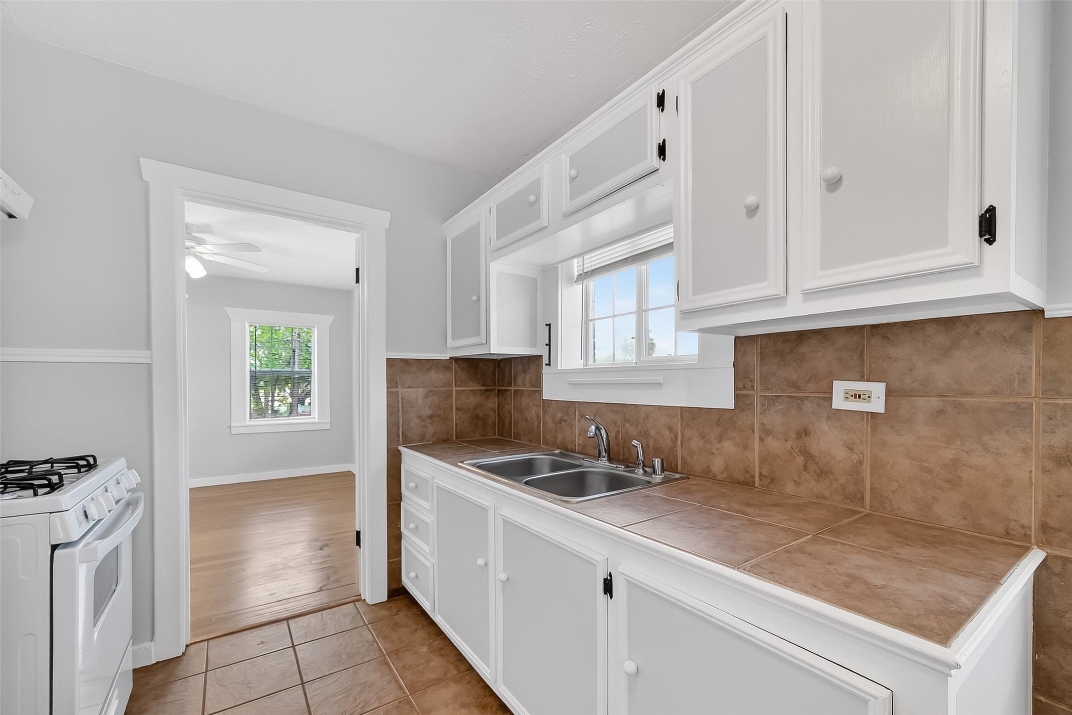 2316 Freeman Street, Unit 6 Houston, TX 77009 - Photo 13 of 25 a kitchen with granite countertop a sink stove and cabinets