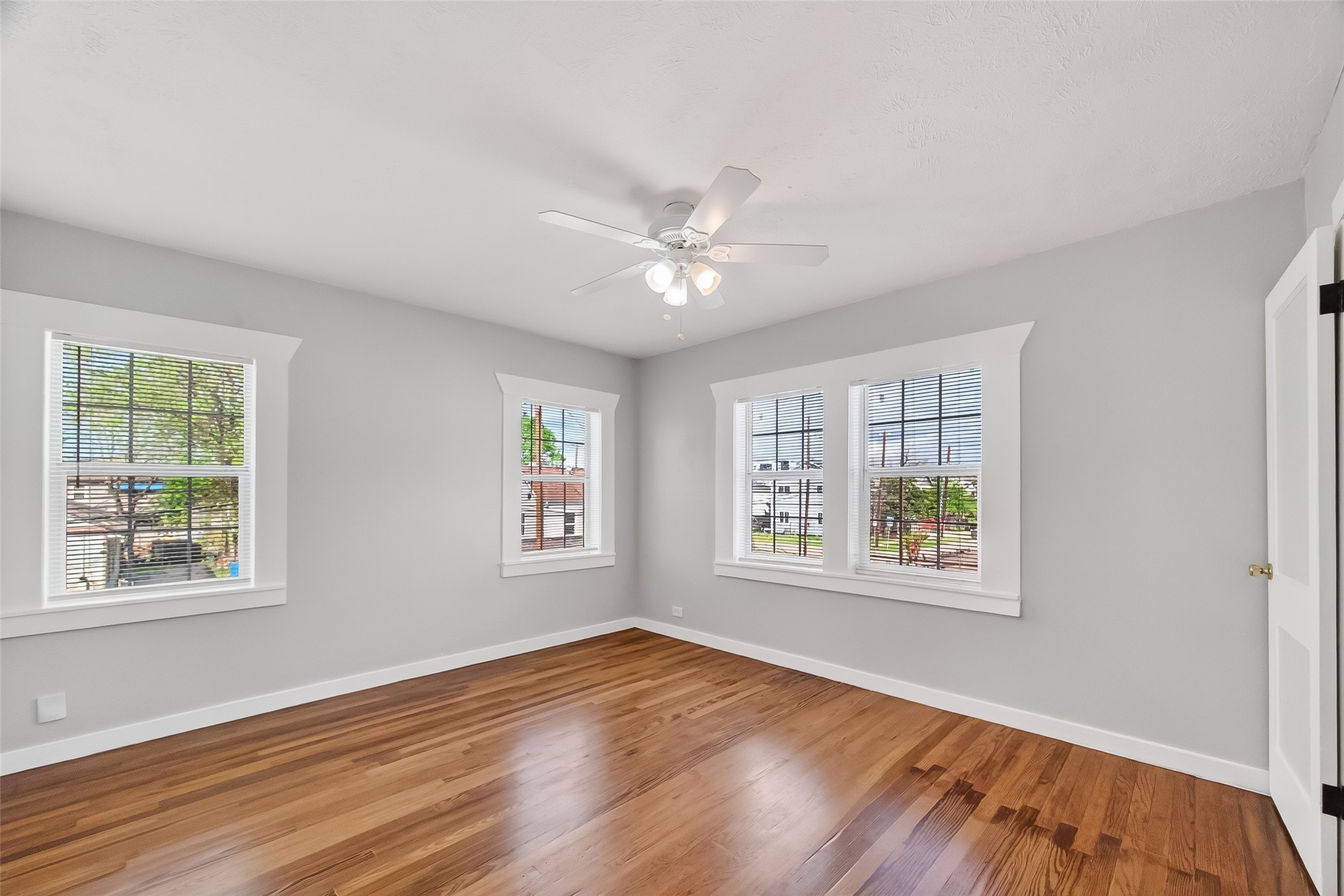 2316 Freeman Street, Unit 6 Houston, TX 77009 - Photo 21 of 25 a view of an empty room with a window and wooden floor