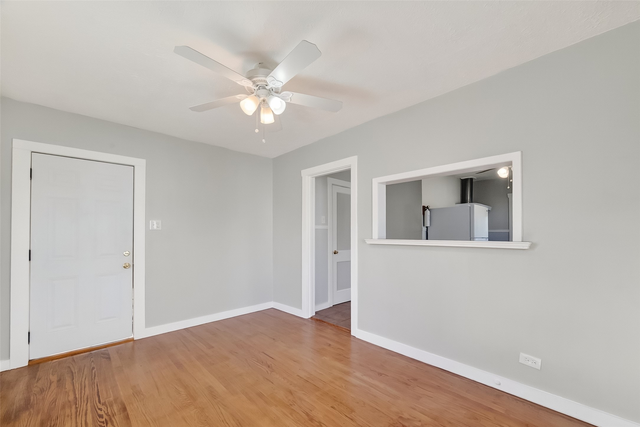 2316 Freeman Street, Unit 6 Houston, TX 77009 - Photo 6 of 25 a view of an empty room with wooden floor and a ceiling fan