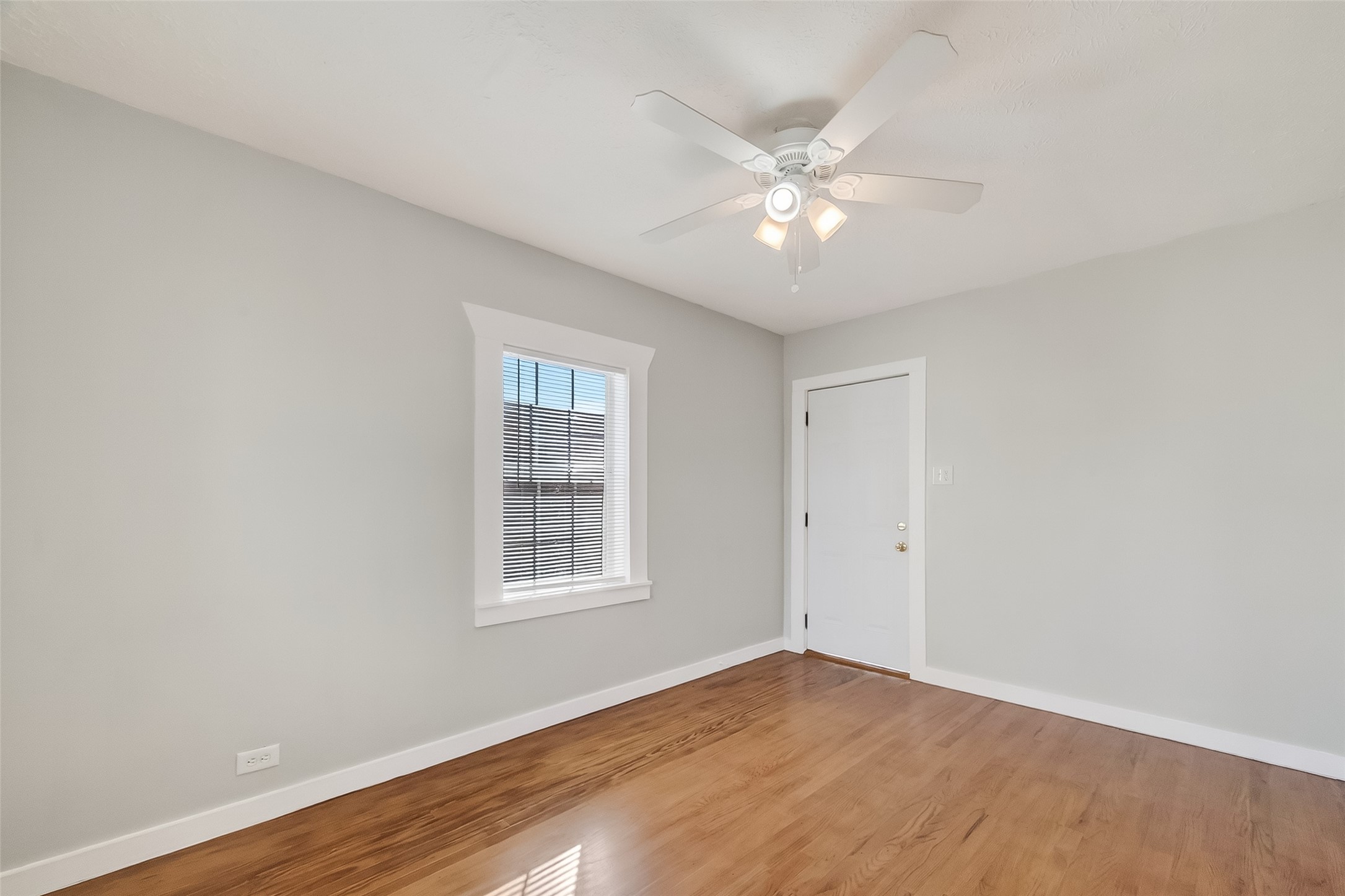 2316 Freeman Street, Unit 6 Houston, TX 77009 - Photo 7 of 25 an empty room with wooden floor fan and windows