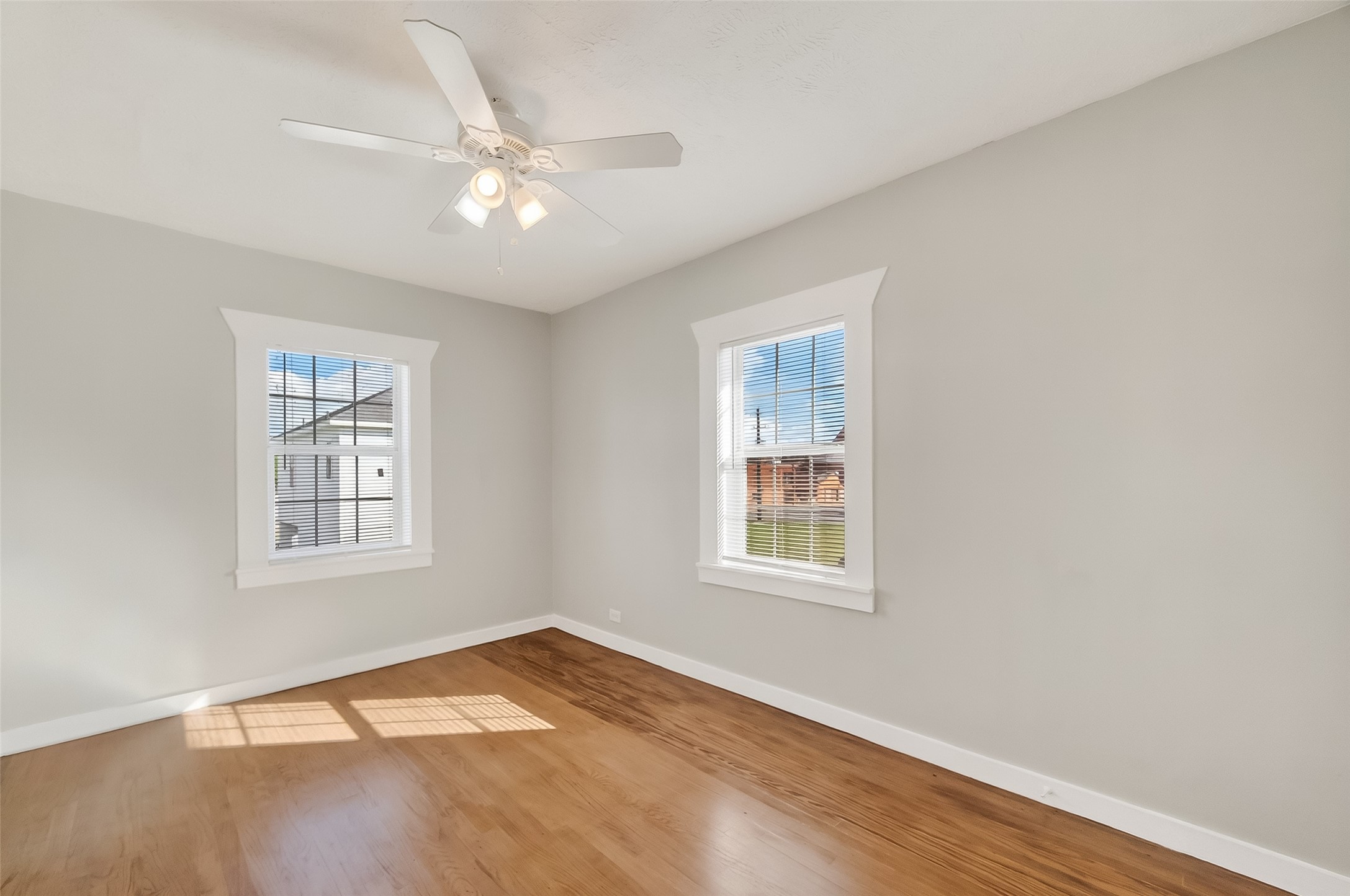 2316 Freeman Street, Unit 6 Houston, TX 77009 - Photo 9 of 25 an empty room with wooden floor windows and fan