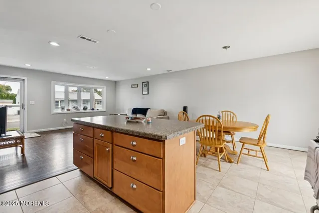 a spacious bathroom with a granite countertop sink and a mirror