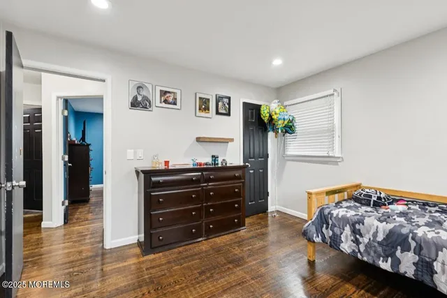 a bedroom with a bed and a mirror