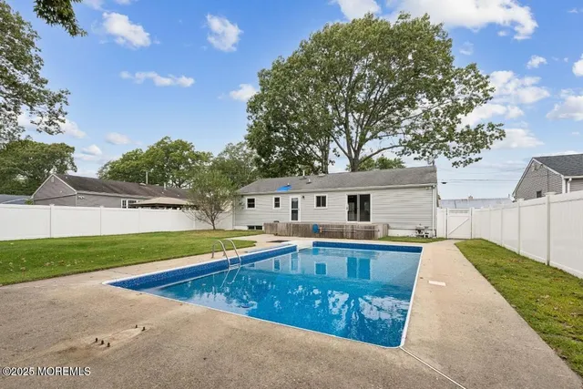 a front view of house with yard and swimming pool