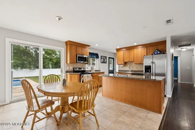 a dining room with furniture a window and kitchen view