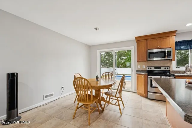 a view of a dining room with furniture and a kitchen