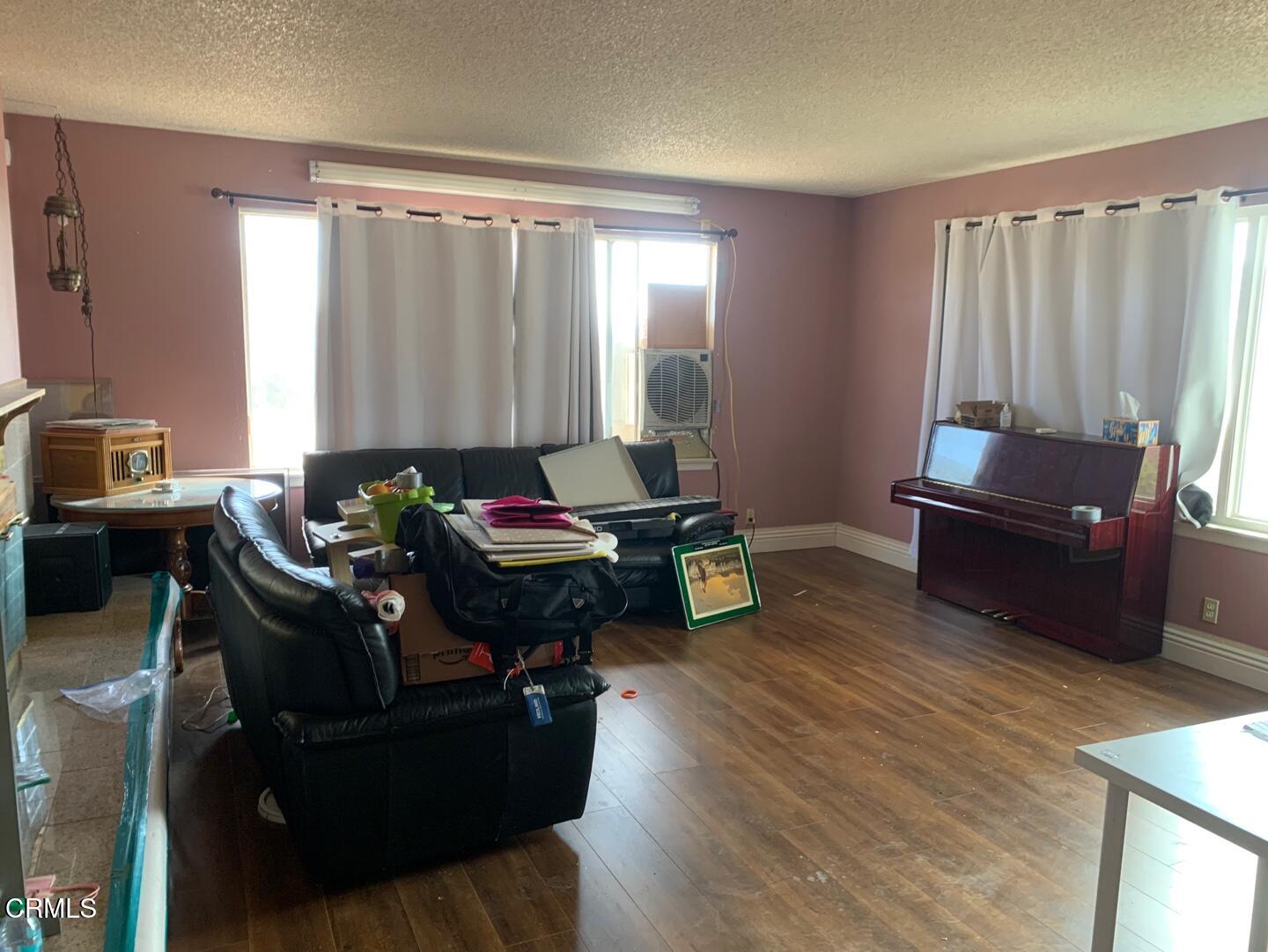 18534 Symeron Road Apple Valley, CA 92307 - Photo 2 of 10 a living room with furniture and a large window
