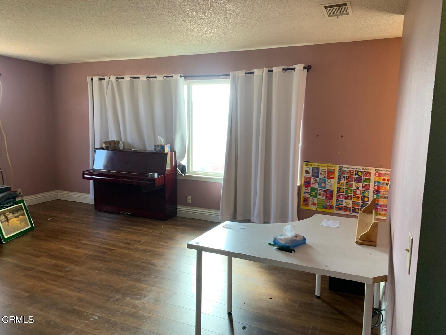 18534 Symeron Road Apple Valley, CA 92307 - Photo 3 of 10 a view of a workspace with furniture and window