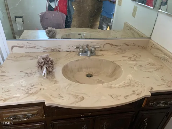 a bathroom with a sink and a mirror