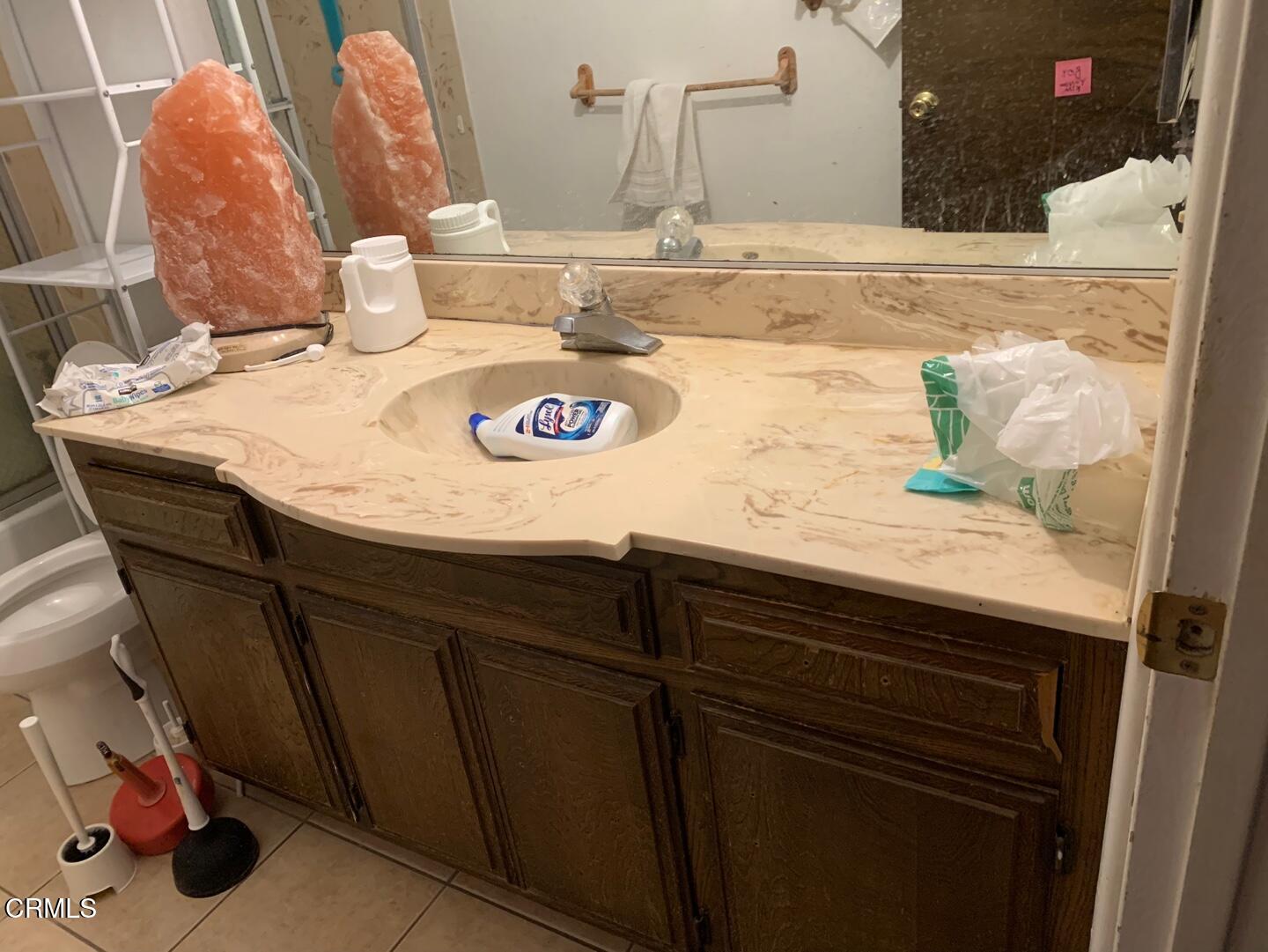18534 Symeron Road Apple Valley, CA 92307 - Photo 5 of 10 a bathroom with a granite countertop sink a toilet and a mirror
