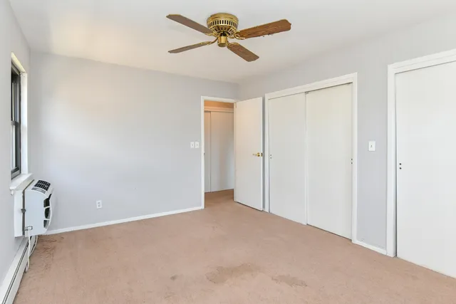 a view of a room with a ceiling fan