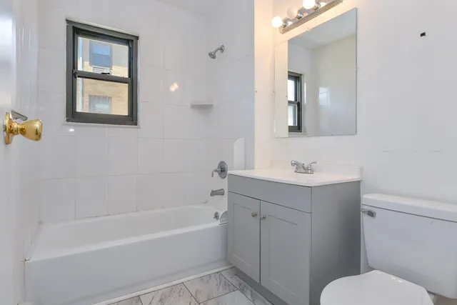 a bathroom with a sink toilet and bathtub
