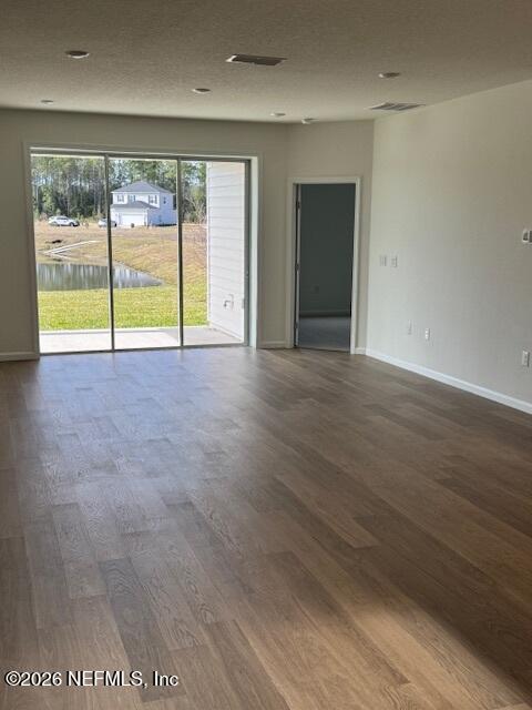 73 Chestnut Grv Road St. Augustine, FL 32092 - Photo 2 of 18 a view of an empty room with wooden floor and a window