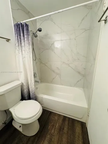 a bathroom with a toilet and a bathtub