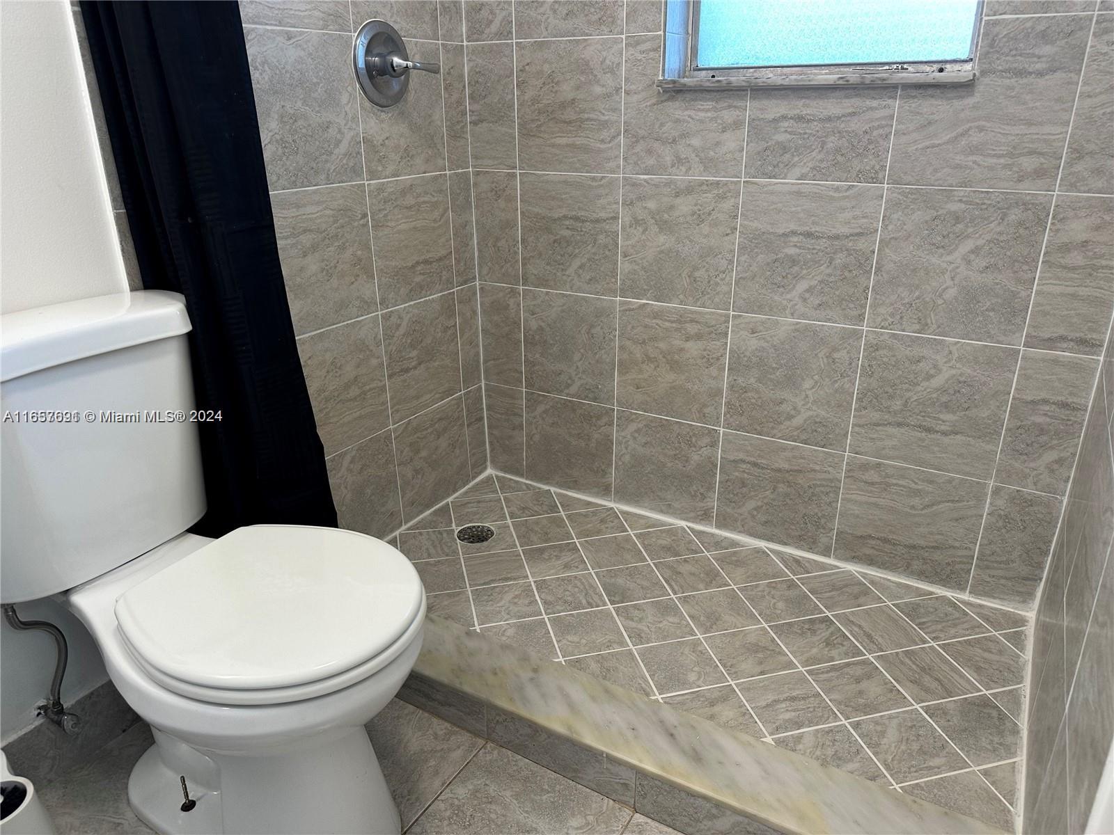 Sequoia Gardens Condominiums Deerfield Beach, FL 33441 - Photo 12 of 25 a bathroom with a toilet and a shower