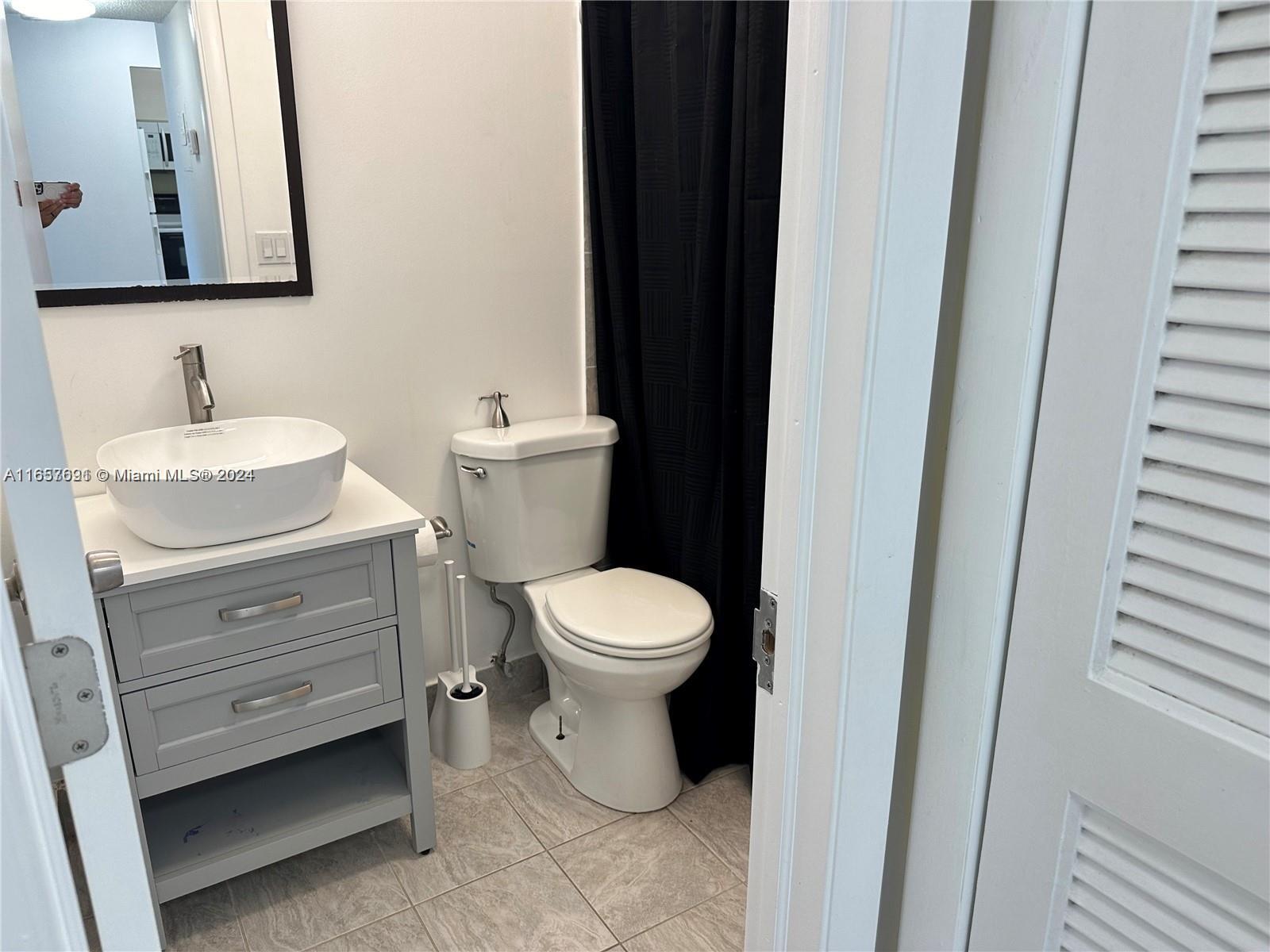 Sequoia Gardens Condominiums Deerfield Beach, FL 33441 - Photo 13 of 25 a bathroom with a granite countertop toilet and a sink
