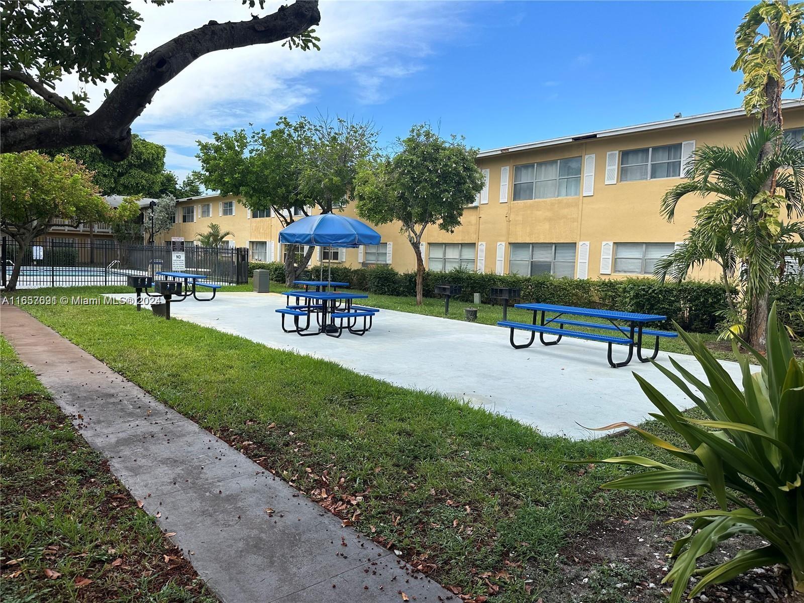 Sequoia Gardens Condominiums Deerfield Beach, FL 33441 - Photo 2 of 25 a swimming pool with outdoor seating and yard