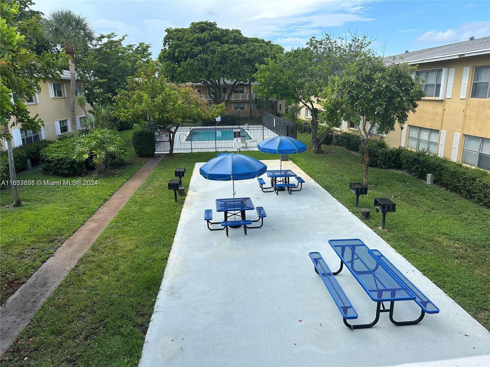 Sequoia Gardens Condominiums Deerfield Beach, FL 33441 - Photo 24 of 25 a view of a backyard with furniture and a garden
