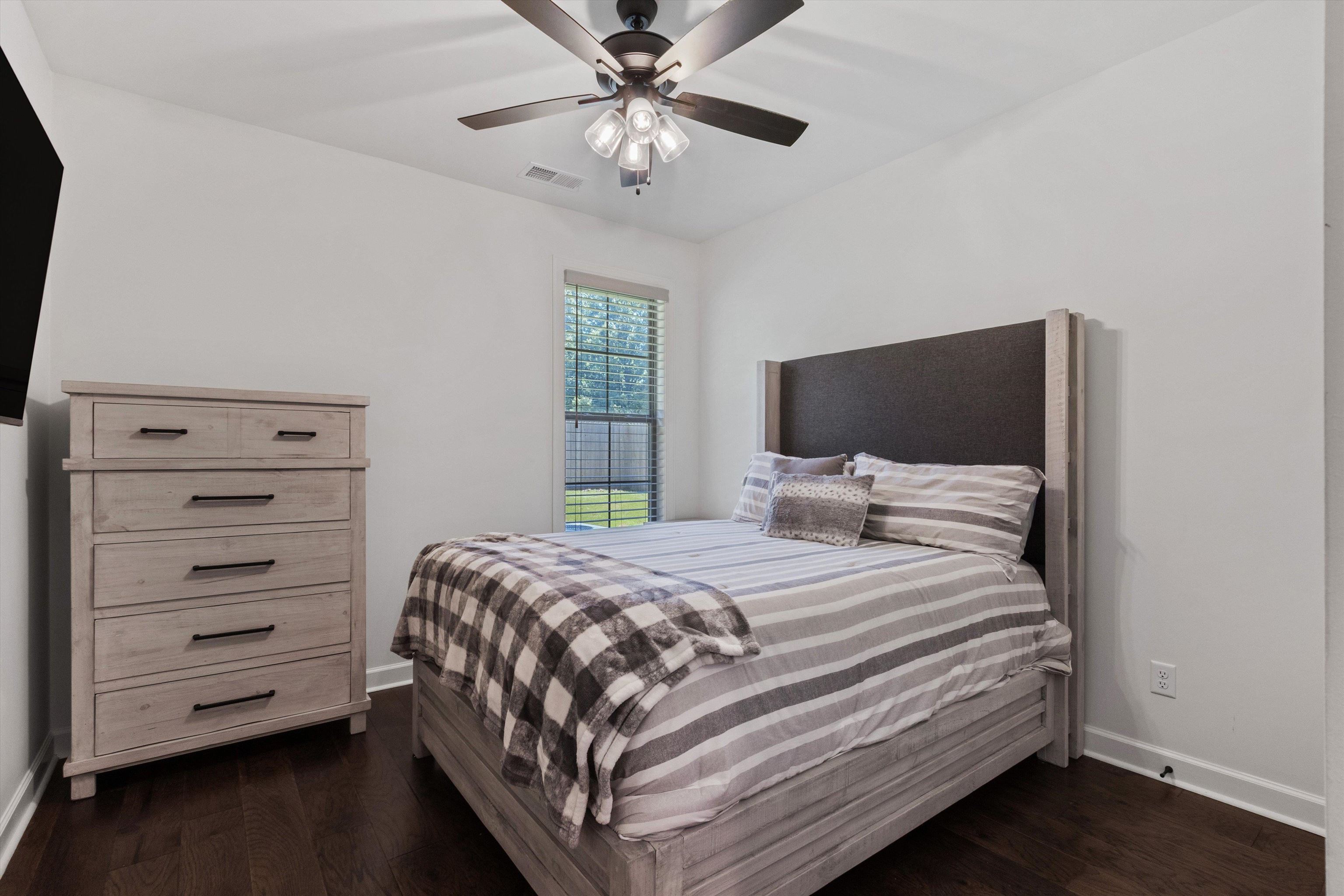65 Watson Road Oakland, TN 38060 - Photo 21 of 40 a bedroom with a bed and a chandelier
