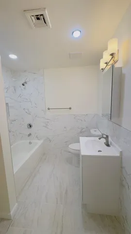 a bathroom with a sink a toilet and bathtub