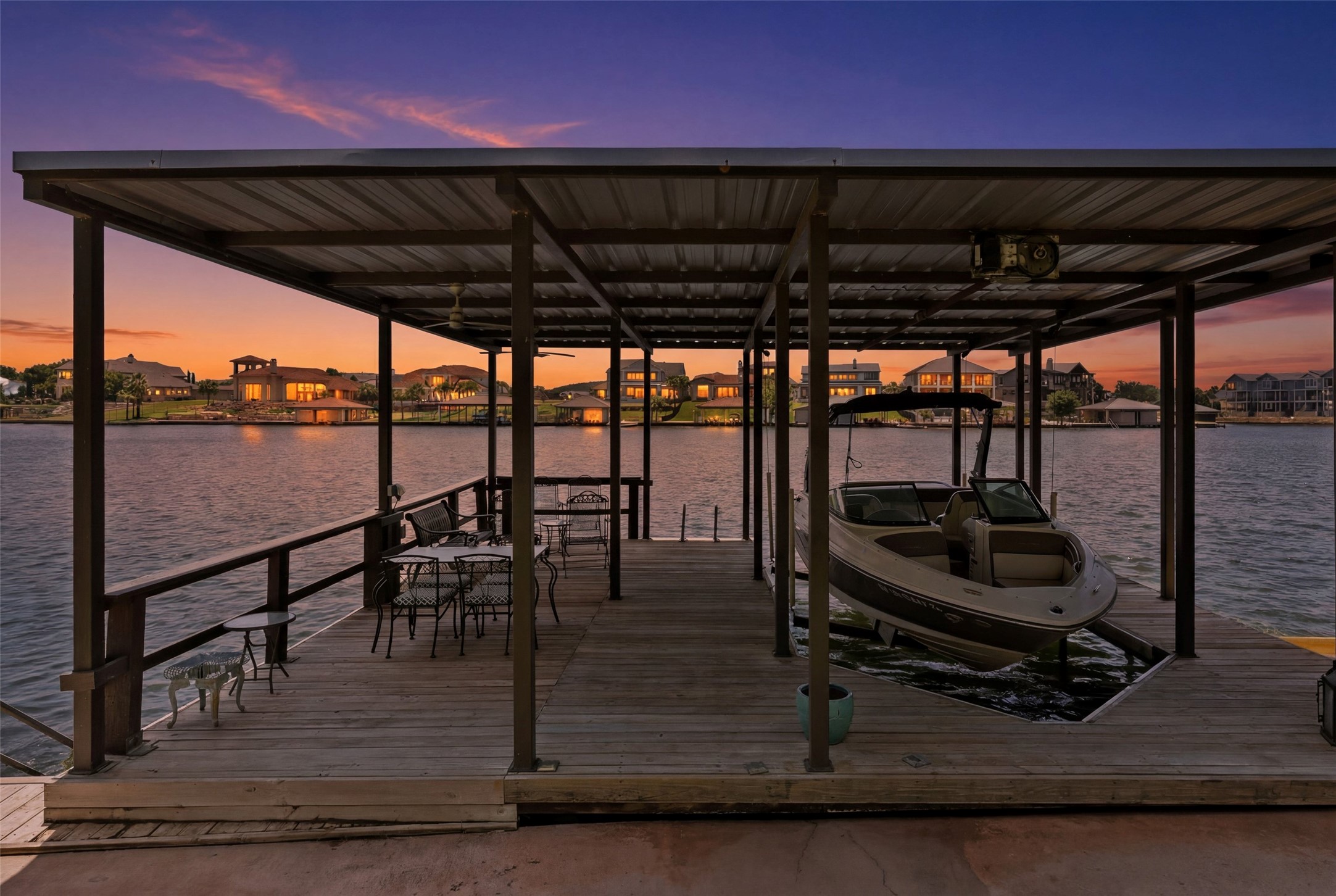 141 Perry Lane Kingsland, TX 78639 - Photo 10 of 40 A private boat dock and covered deck offer peaceful water access and serene sunset views.