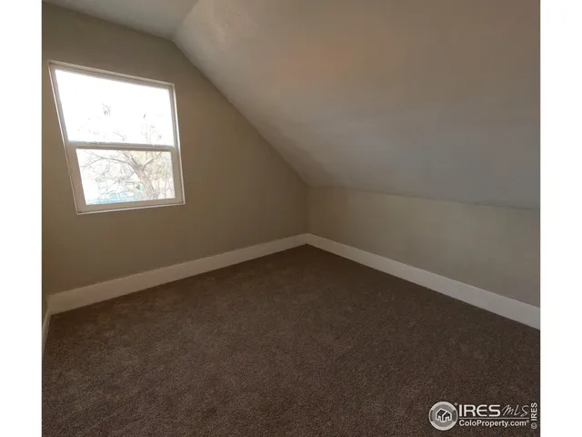 a bedroom with a bed and a book shelf