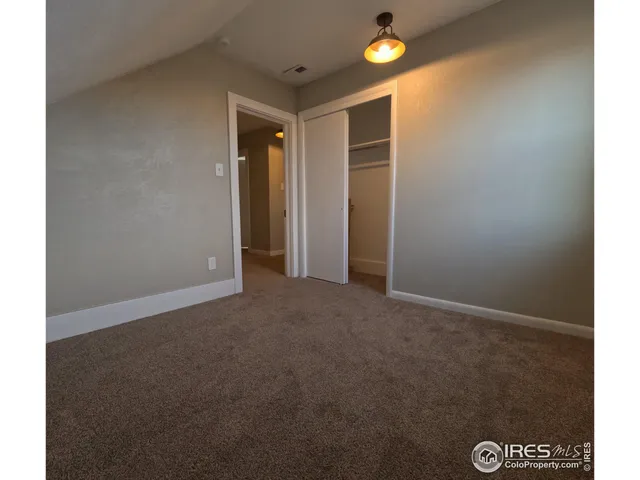 a bathroom with a toilet sink vanity and mirror