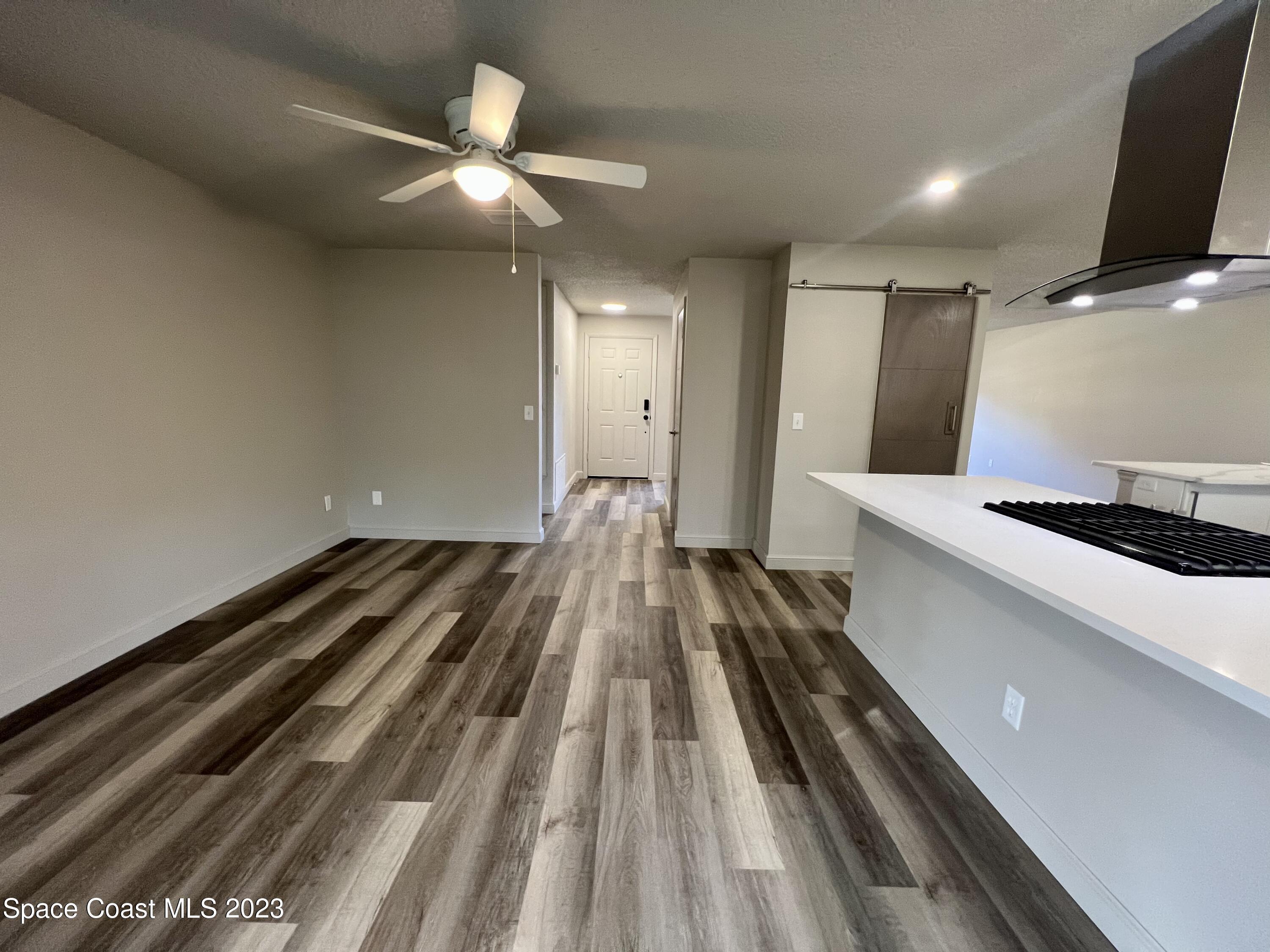 1095 Coronado Drive Rockledge, FL 32955 - Photo 13 of 28 a view of a living room with wooden floor