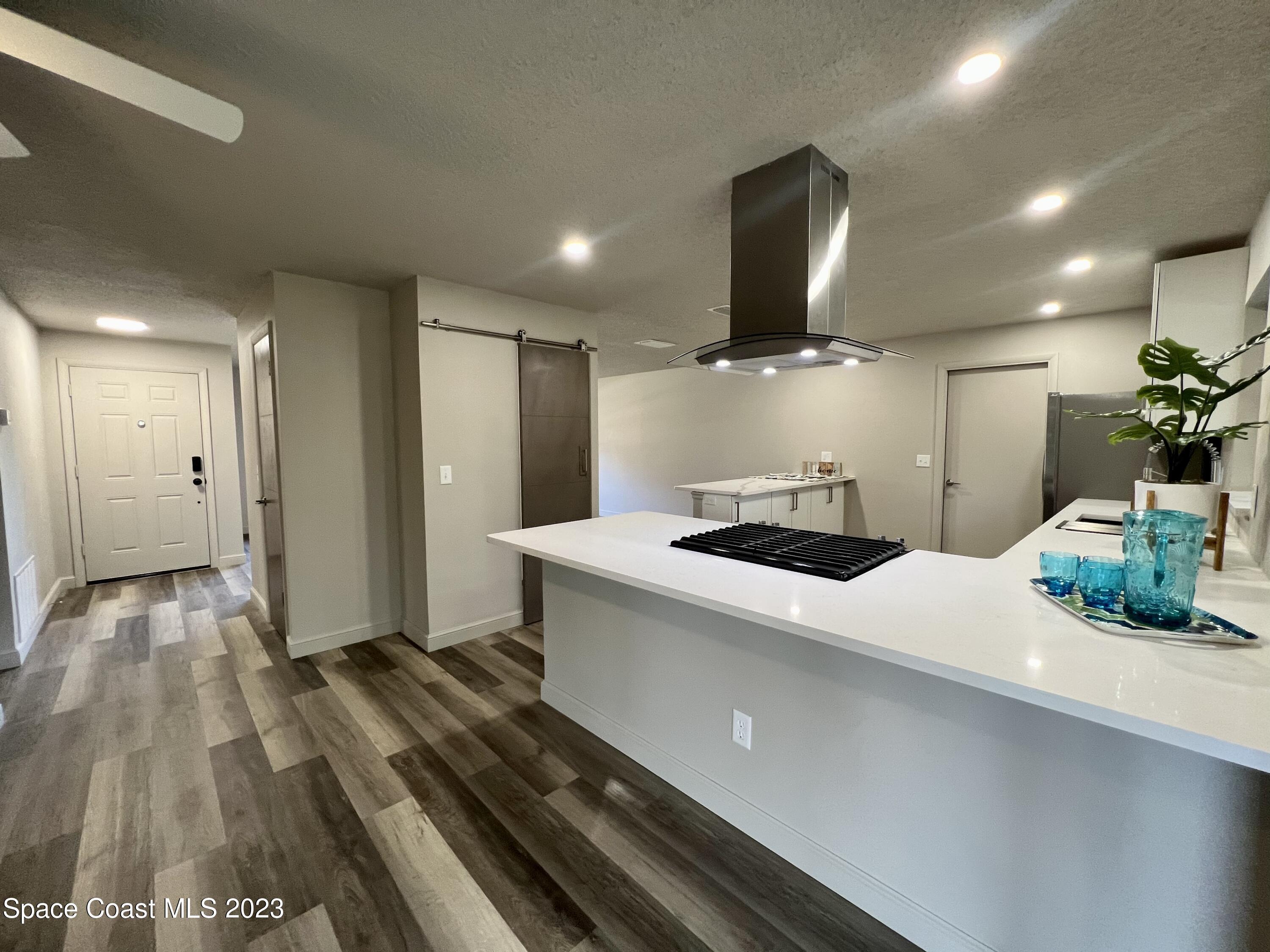 1095 Coronado Drive Rockledge, FL 32955 - Photo 14 of 28 a kitchen with a sink and a refrigerator