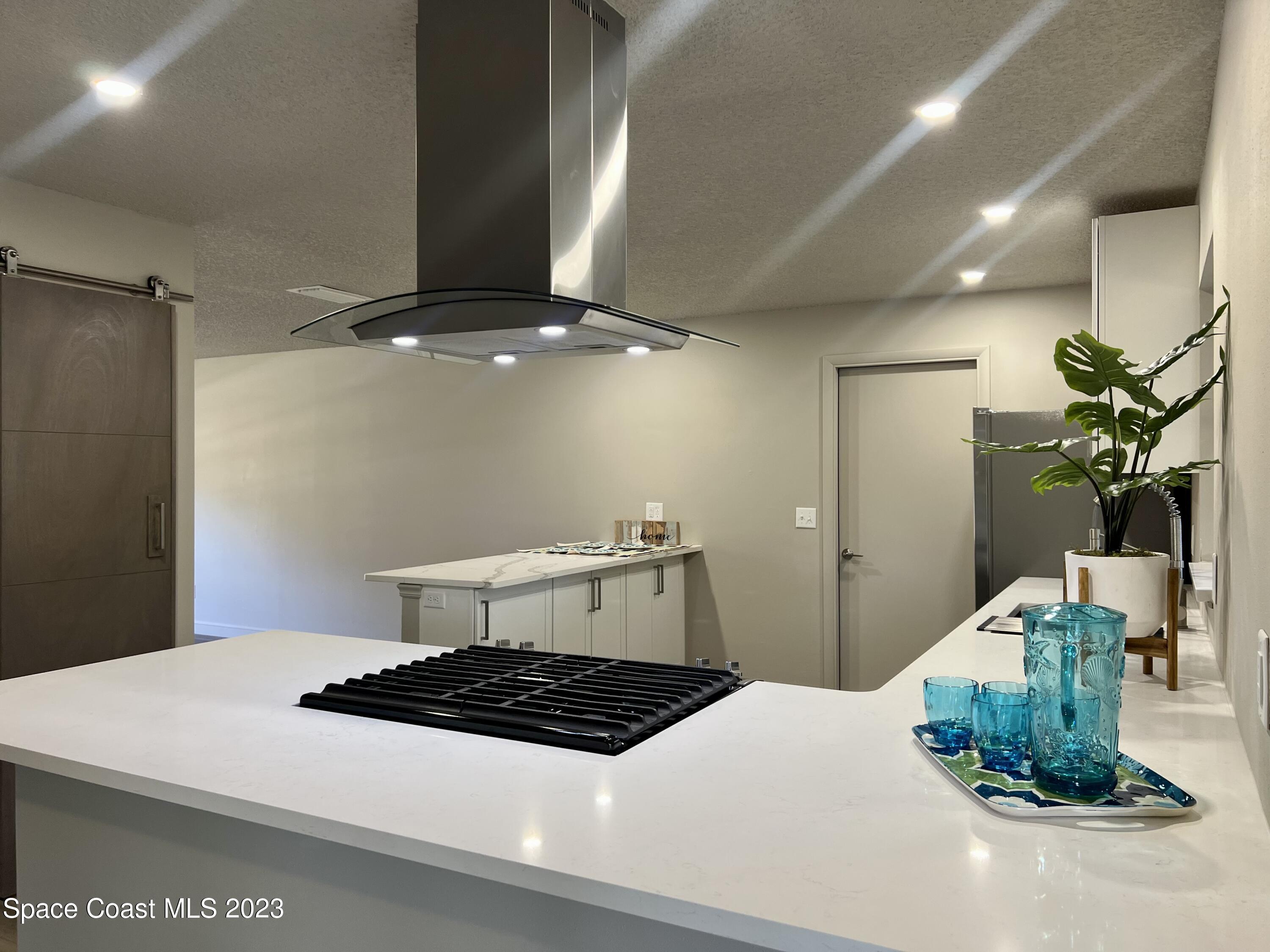 1095 Coronado Drive Rockledge, FL 32955 - Photo 15 of 28 a bedroom with a bed and a chandelier