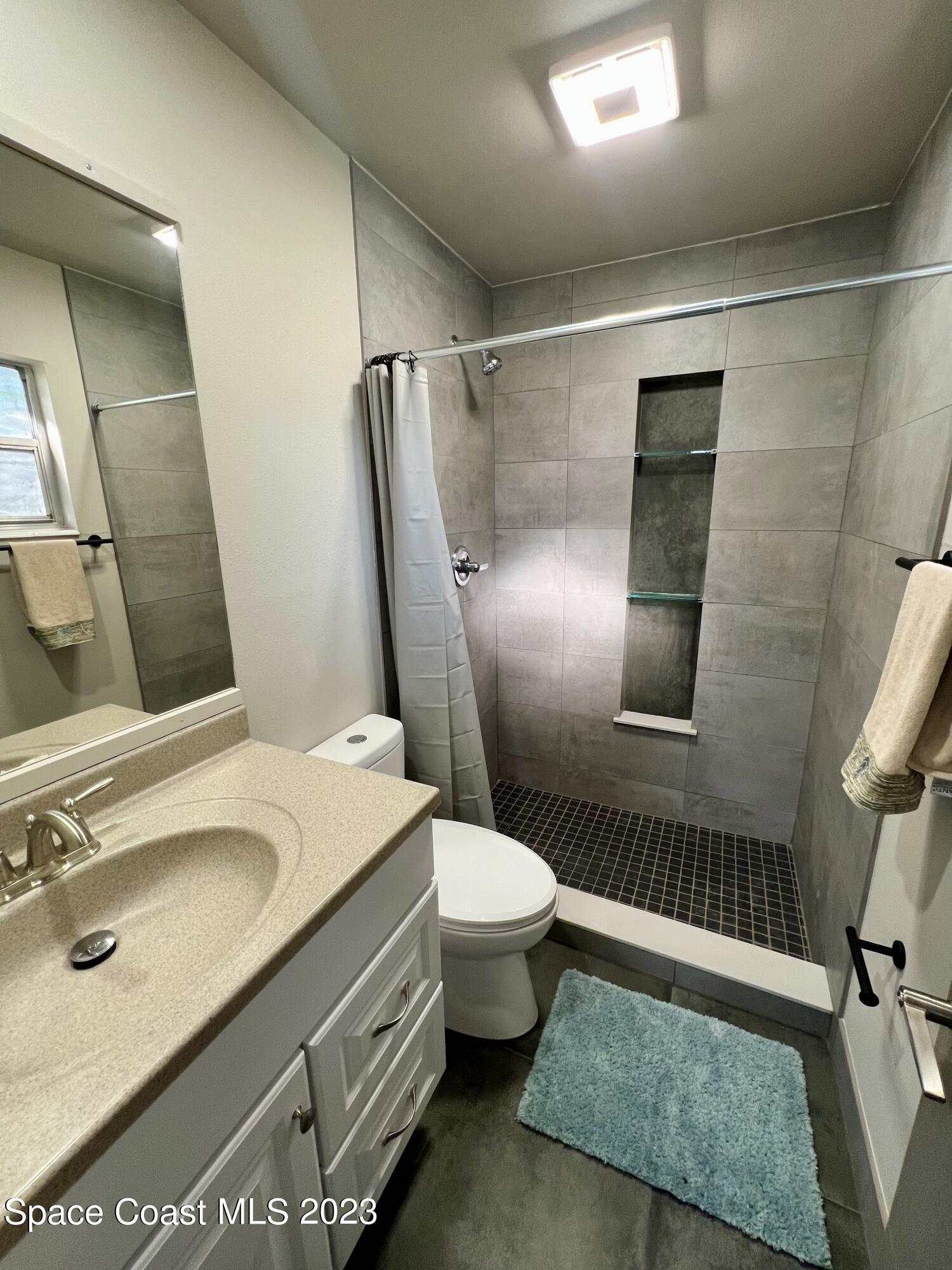 1095 Coronado Drive Rockledge, FL 32955 - Photo 20 of 28 a bathroom with a sink toilet and shower