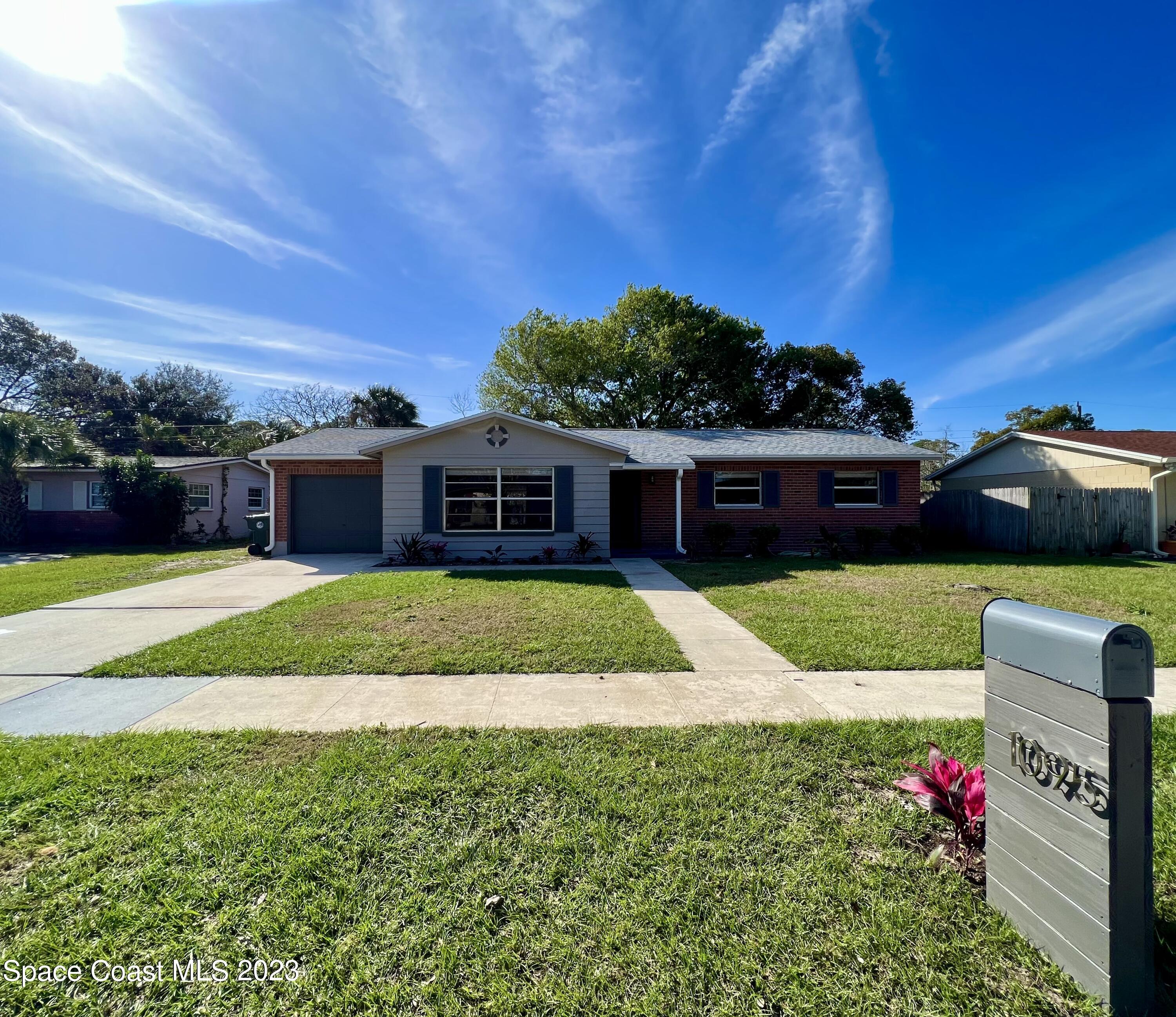 1095 Coronado Drive Rockledge, FL 32955 - Photo 2 of 28 a front view of a house with a garden