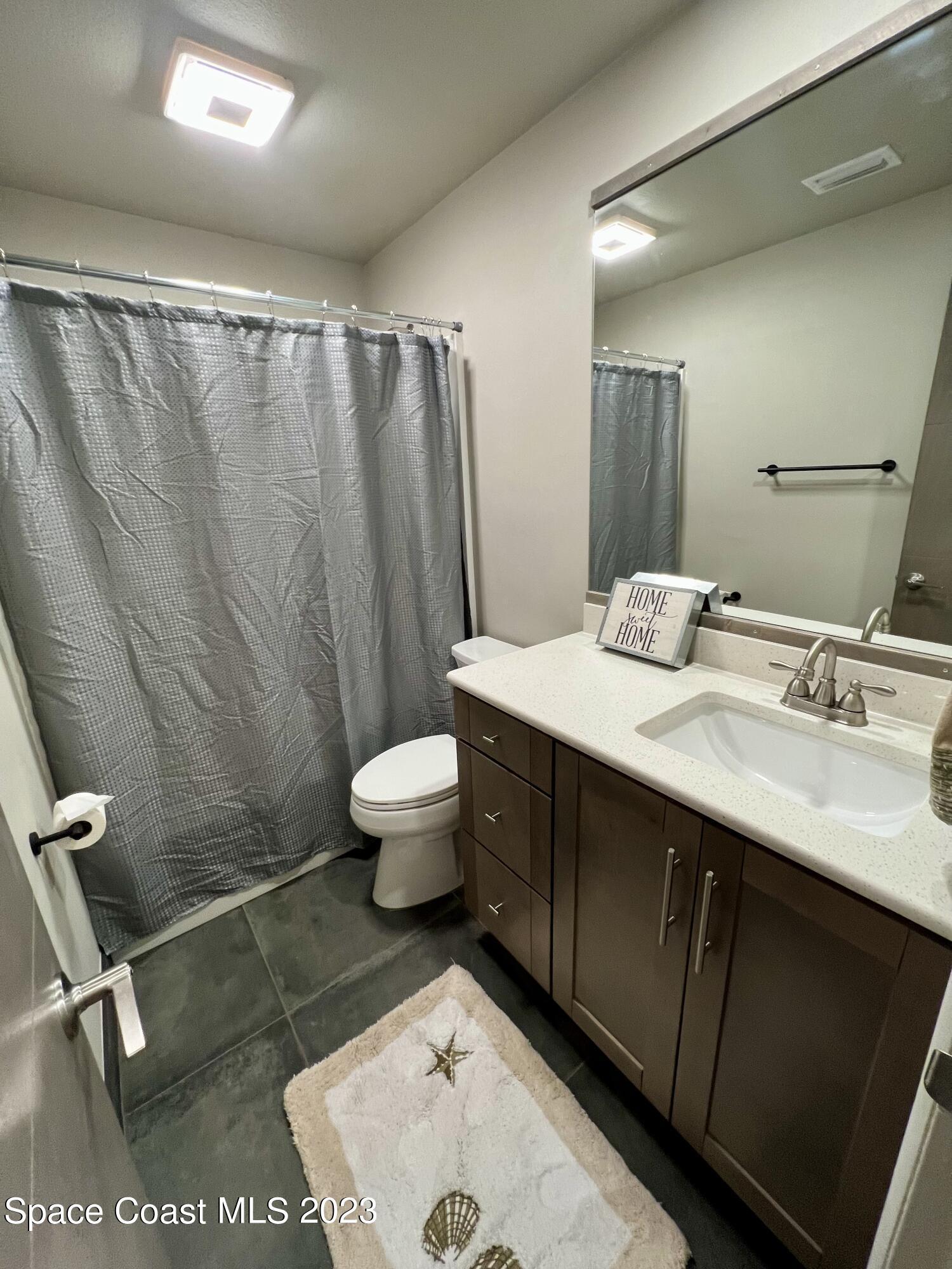 1095 Coronado Drive Rockledge, FL 32955 - Photo 24 of 28 a bathroom with a sink toilet and shower