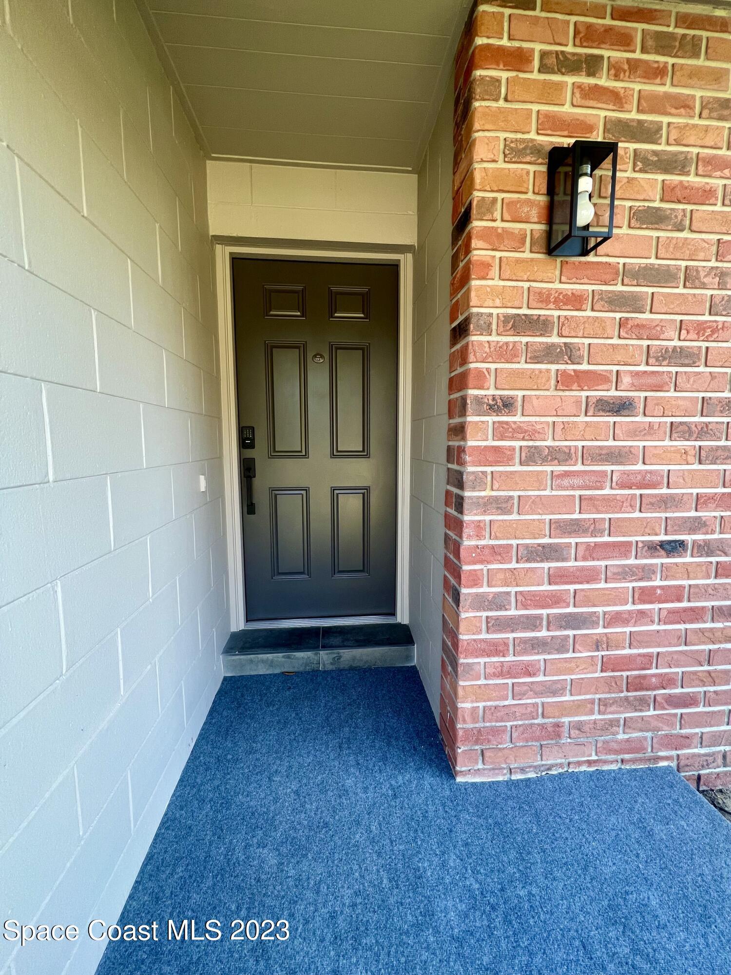 1095 Coronado Drive Rockledge, FL 32955 - Photo 3 of 28 a view of front door of a house with a yard